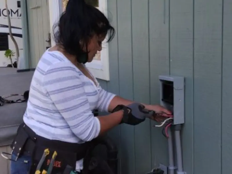 Licensed electrician wiring an exterior subpanel in Collins